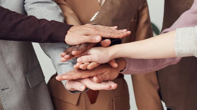 photo of people holding each other s hands